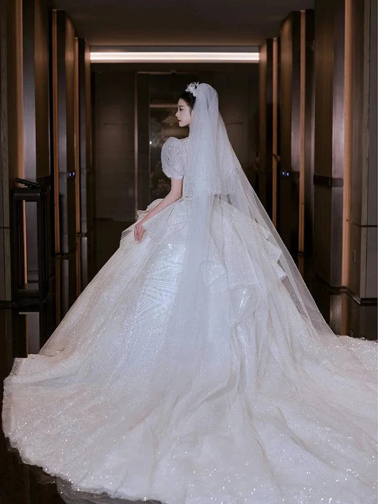 Elegant LYNHURD! wedding gown with chapel train, designed for brides, featuring intricate details and luxurious fabric.