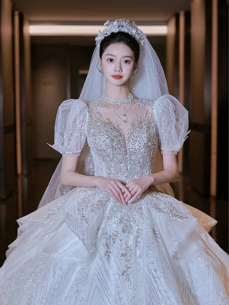 Elegant LYNHURD! wedding gown with chapel train, designed for brides, showcasing luxurious fabric and intricate details.