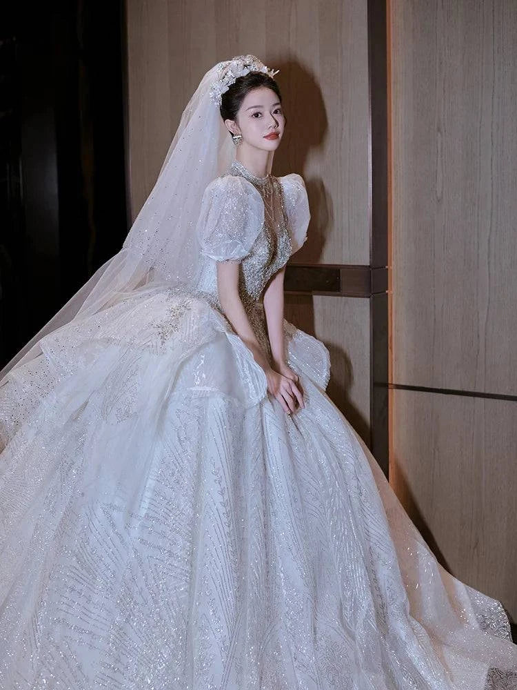 Elegant LYNHURD! wedding gown with chapel train, perfect for brides and wedding parties, showcasing luxurious design.