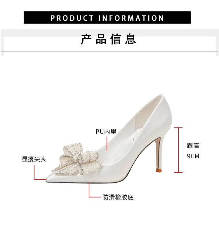 White satin wedding shoes with stiletto heels, pointed toe, pearl bow detail by LYNHURD for brides.