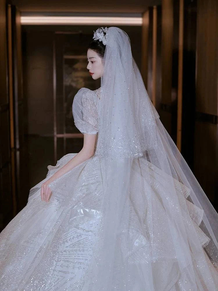 Elegant LYNHURD wedding gown with chapel train, featuring luxurious design for brides at wedding parties.