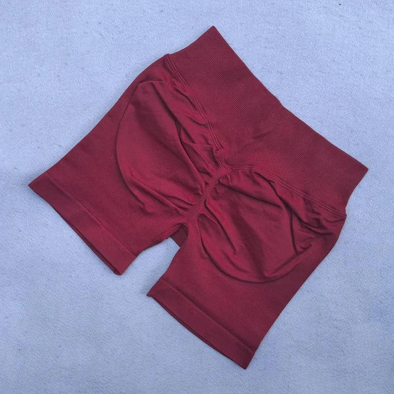 LYNHURD women's yoga set featuring backless halter top and high waist seamless shorts in a gym setting.