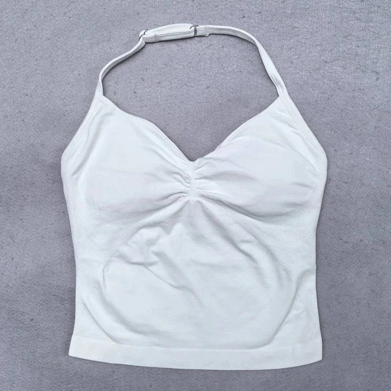 Women’s LYNHURD! yoga set featuring a backless halter top and high-waist seamless shorts in a gym setting.