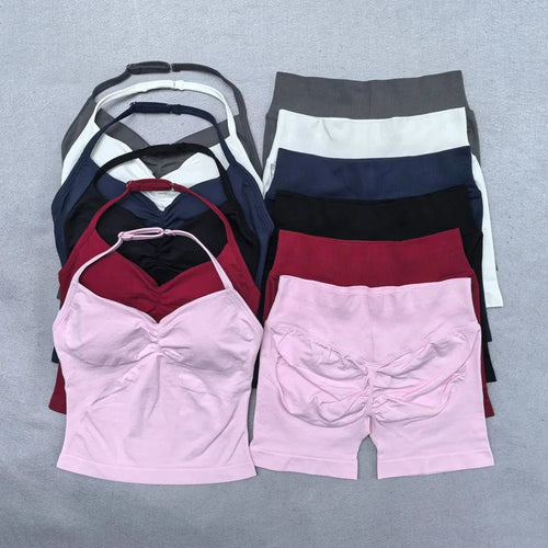 Women’s LYNHURD! yoga set featuring backless halter top and high-waist seamless shorts in a gym setting.