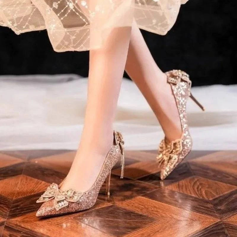 Silver high heels by LYNHURD with a pointed toe and bow detail, featuring a crystal shine perfect for casual wear.